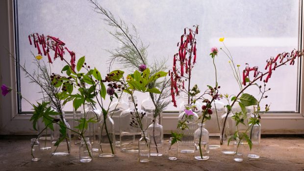 Making a floral display with vintage bottles