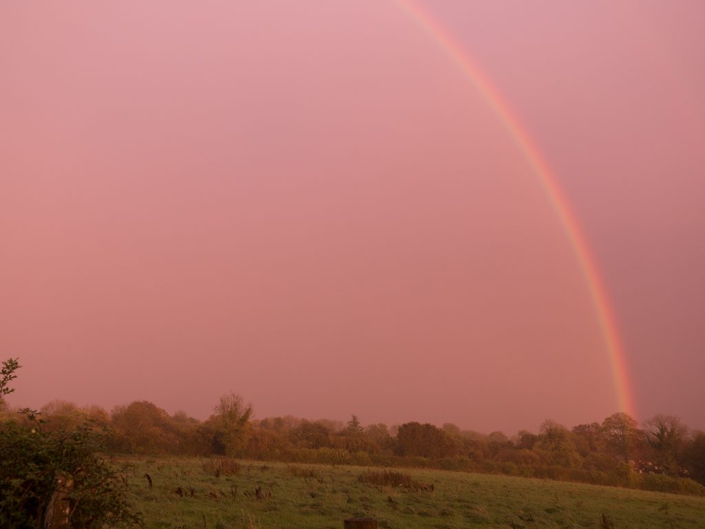 landscape photo of a rainbow when hurricane ophelia hit england