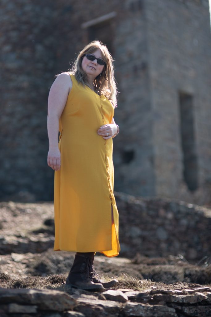 Over 40 style blogger wearing a yellow dress