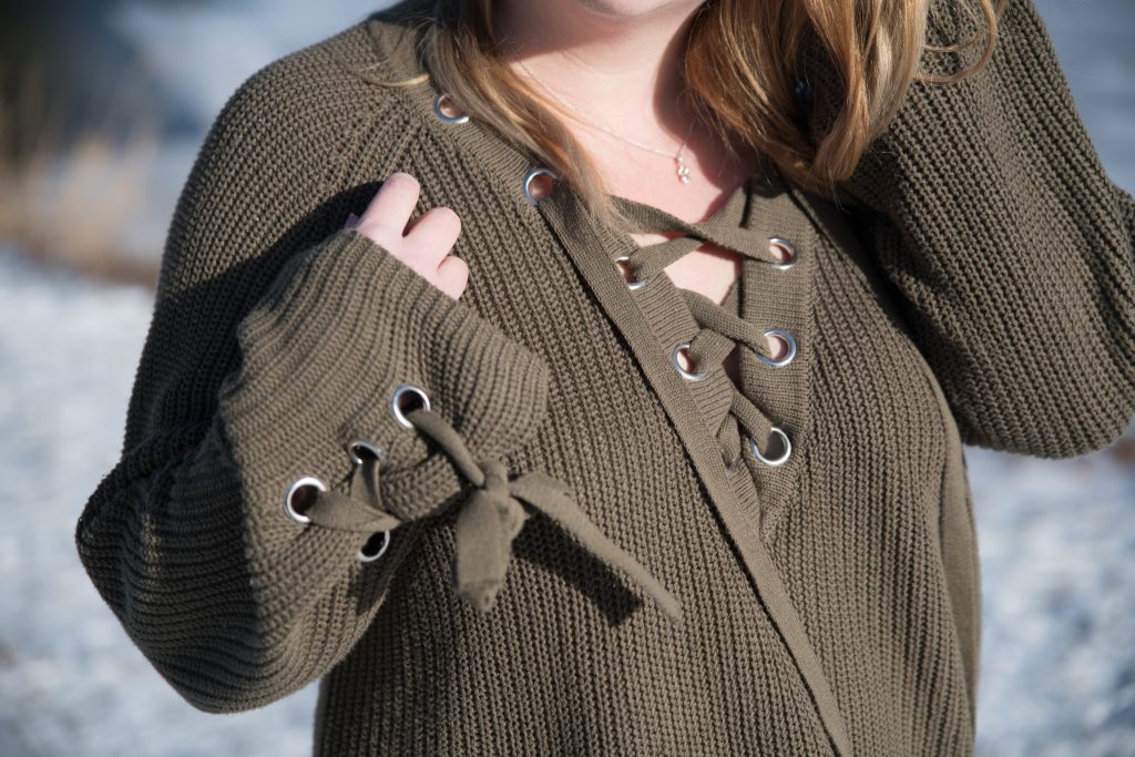 Lace-up details on a khaki jumper